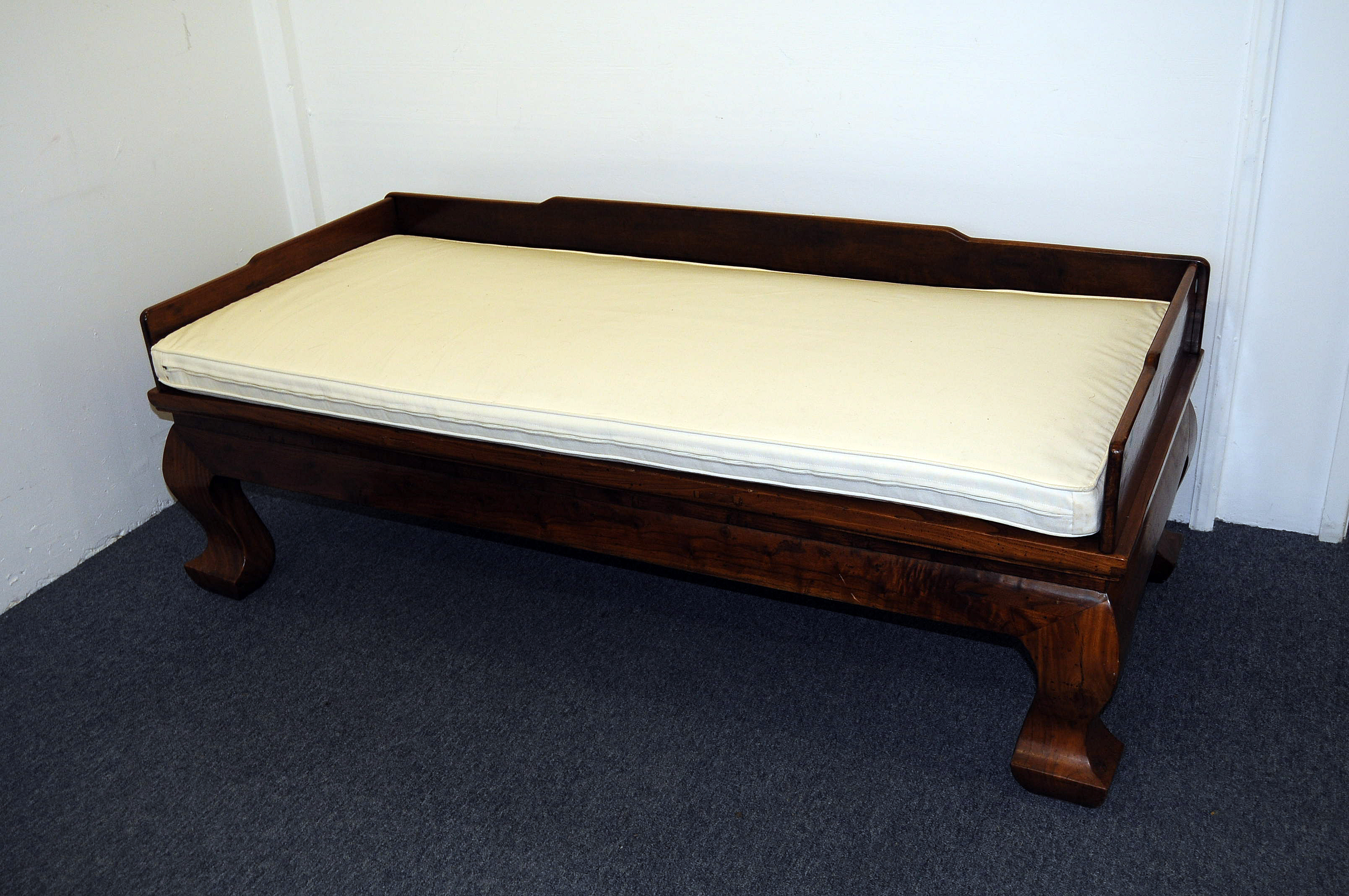 A Chinese Qing dynasty Luohan bed, or opium bed, from the Shangxi province of China, carved from elm