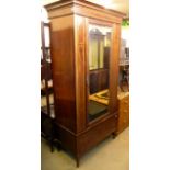 An Edwardian mahogany single door wardrobe, mirror to door with satin wood banding, and square