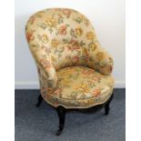 An Edwardian period upholstered bedroom chair, with flowered material on moulded frame