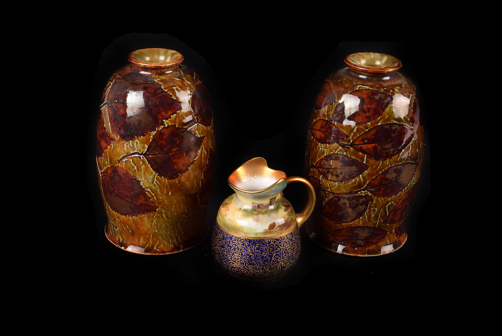 A pair of early 20th century Royal Doulton stoneware vase, having leaf design, marked to bases,