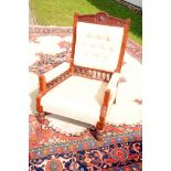 An Edwardian armchair, having modern upholstery to the stained beech frame