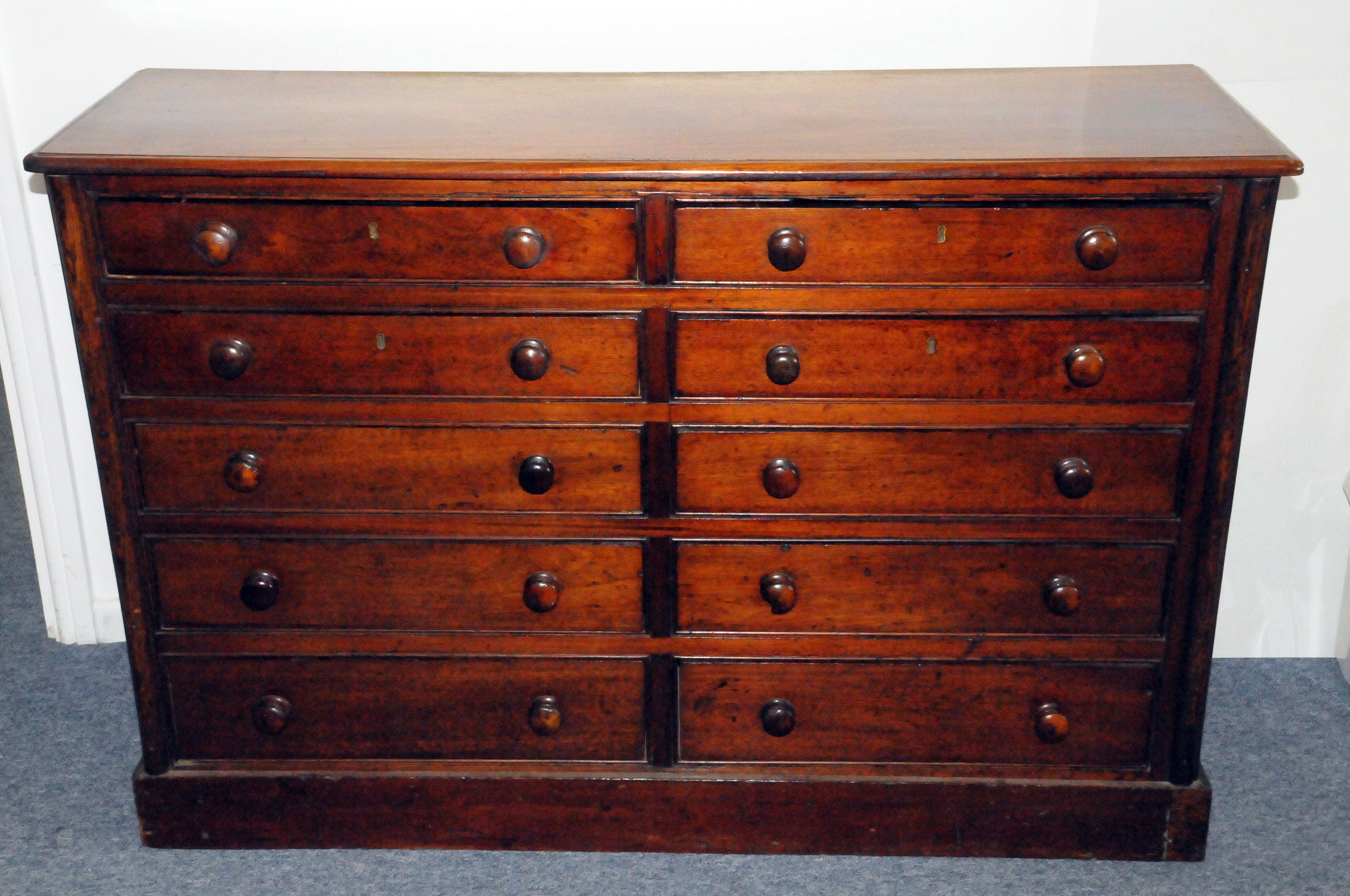 A Victorian mahogany double chest of drawers, having two sets of five graduated drawers with