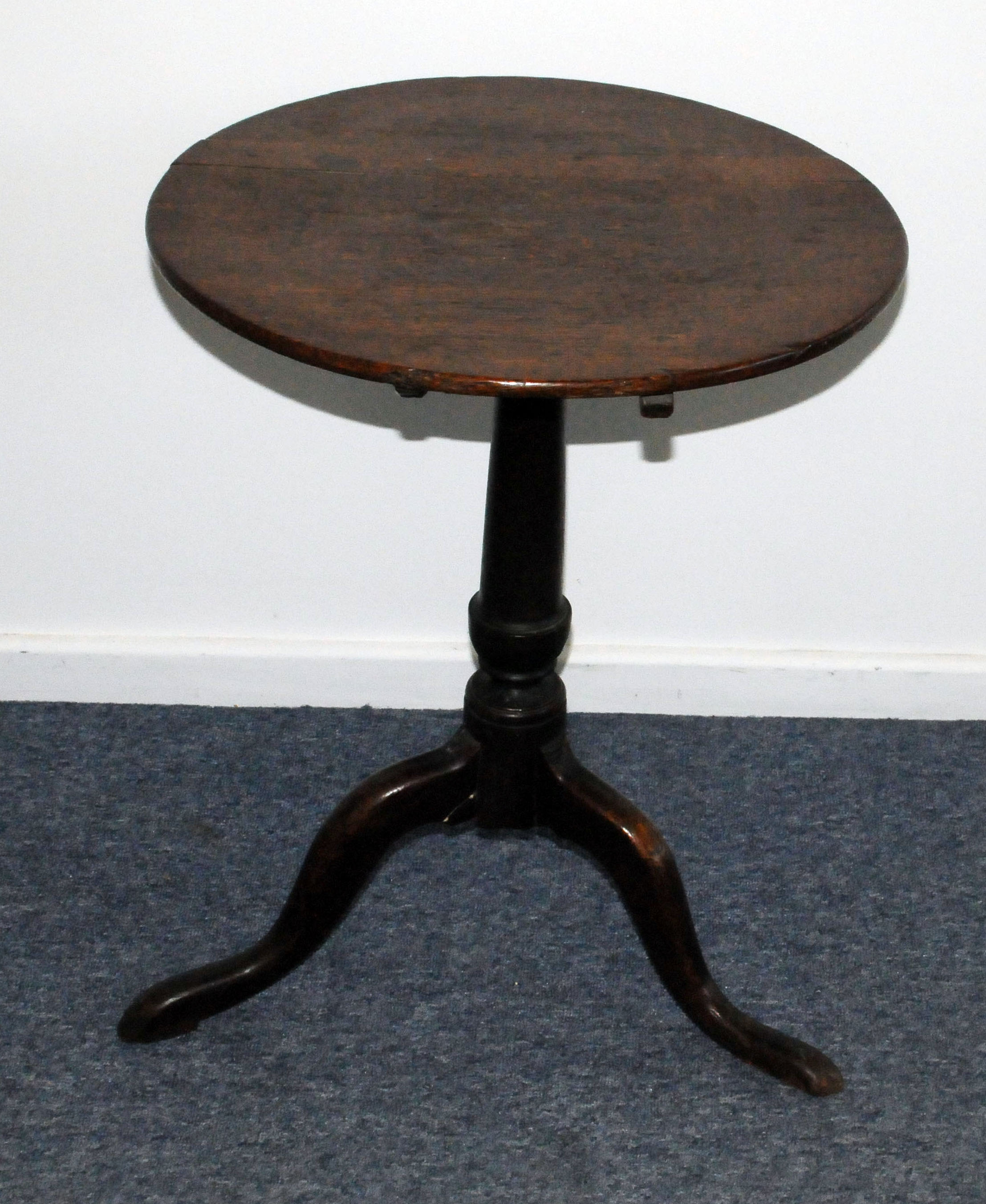 A Georgian oak tilt top occasional table, with circular top, repaired, on tripod base with pad feet,