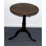 A Georgian oak tilt top occasional table, with circular top, repaired, on tripod base with pad feet,