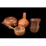 A collection of gourds and carved nuts, including a coquilla nut, an engraved gourd, another