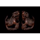A pair of late 19th century Chinese hardwood temple dogs, the well carved Fo dogs with glass bead