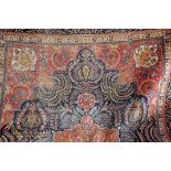 A large Caucasian woollen carpet, or possibly Asfahan, in red and blue with ornate patterns,