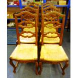 A set of eight oak framed rush seat dining chairs, with carved apron and on cabriole legs, to