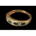 A diamond and emerald seven stone ring, the alternate stones tension set, to a yellow gold shank,
