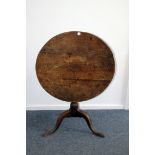 A George III period oak snap top ocassional table, having circular tilt top on tripod base, AF