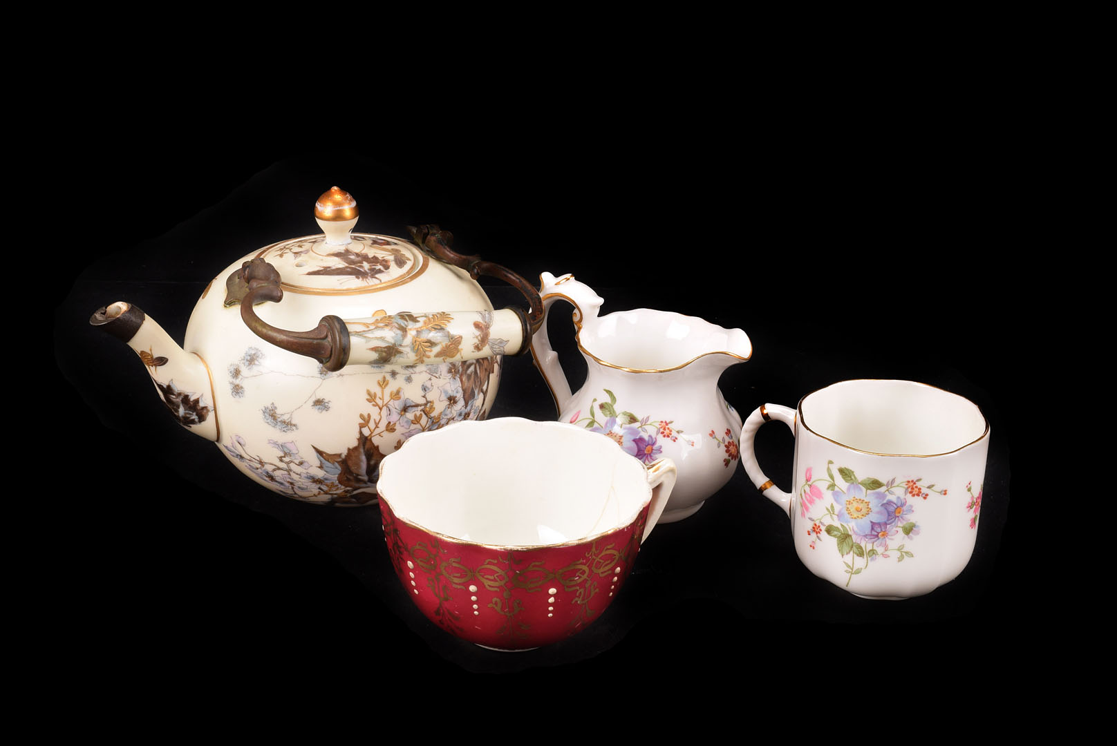 A Japanese part tea service in black and gold, consisting of 5 cups 6 saucers and teapot together