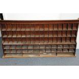 A large 20th century shop or Post Office shelving rack, having multiple pigeon holes