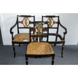 A set of three Edwardian painted dining chairs, in black, having piecred back splat with swan,
