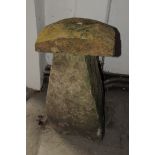 An 18th century carved stone saddlestone support, unusually with rectangular top, on a tapered base,