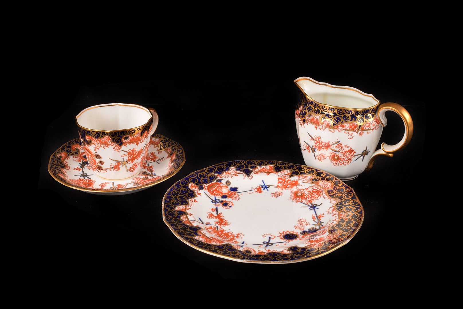 A Royal Crown Derby Part Tea service, with floral pattern of red chrysanthemums and a blue border