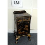 An Art Deco period japanned bedside cabinet, in black lacquer with painted figures and heightened in