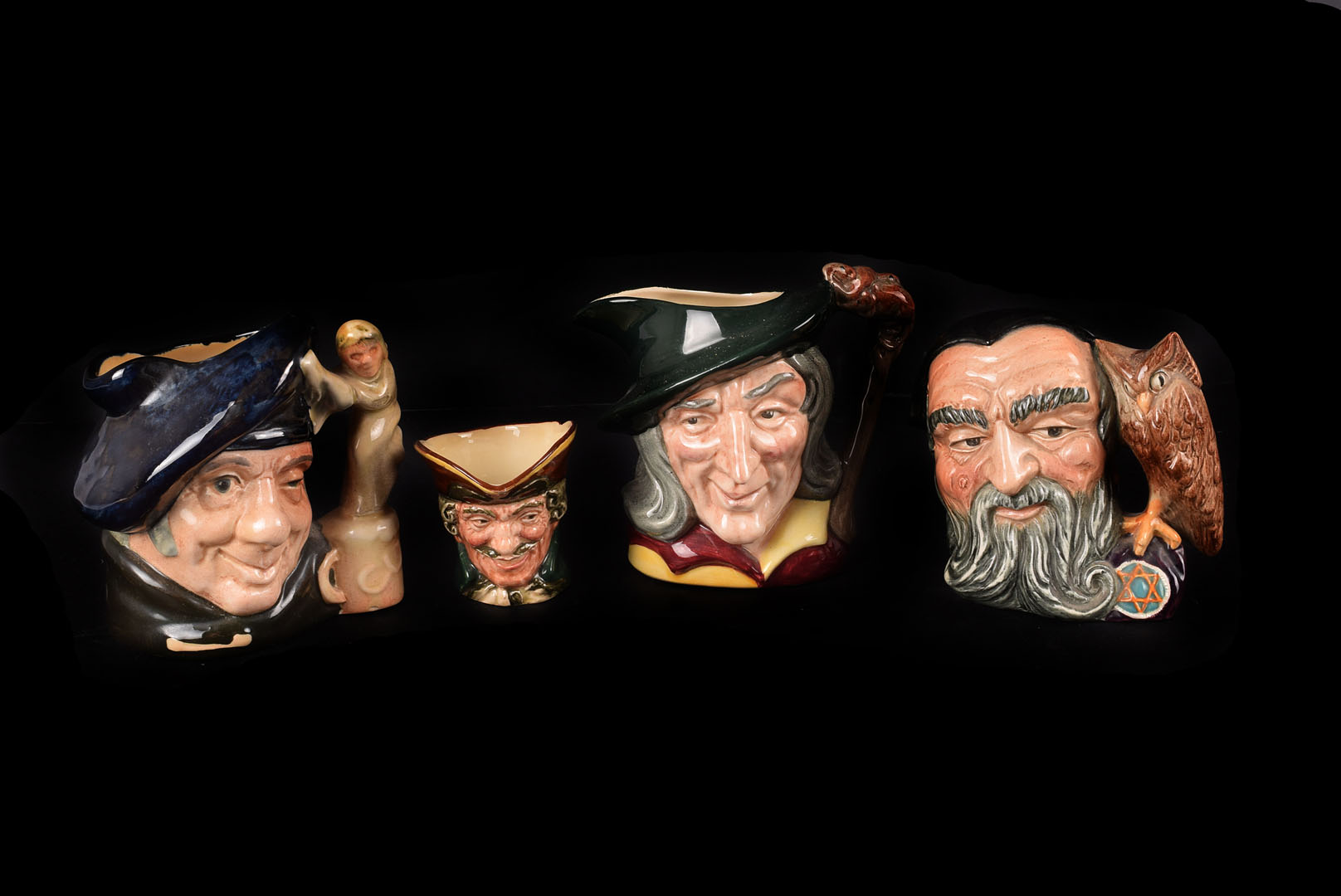 A collection of 13 small Royal Doulton Character Jugs, including Merlin, Tam O'Shanter, Pied