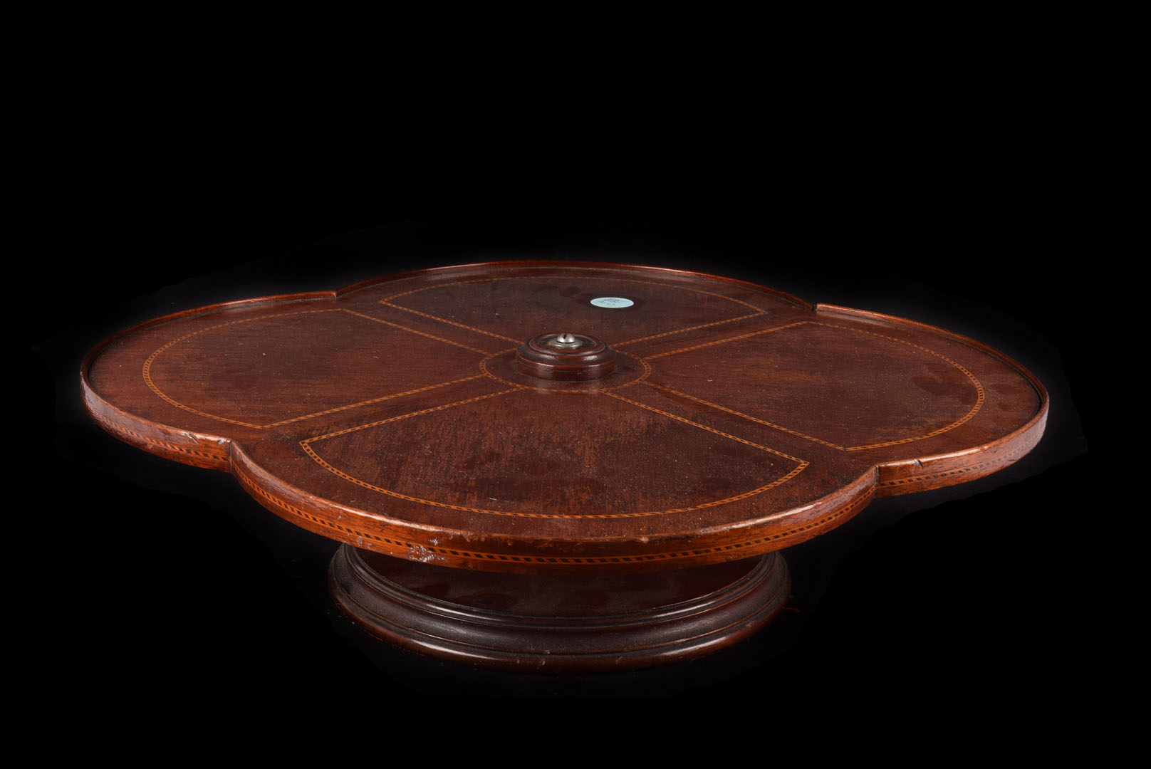 An Edwardian table " Lazy Susan", quatrefoil shape in mahogany with boxwood and ebony dash inlay