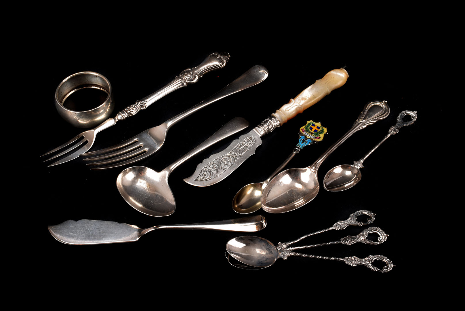 A collection of Georgian & Victorian and later silver flatware and serving utensils, including a mop