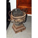 A Regency period cast iron fire basket, in the neoclassical taste