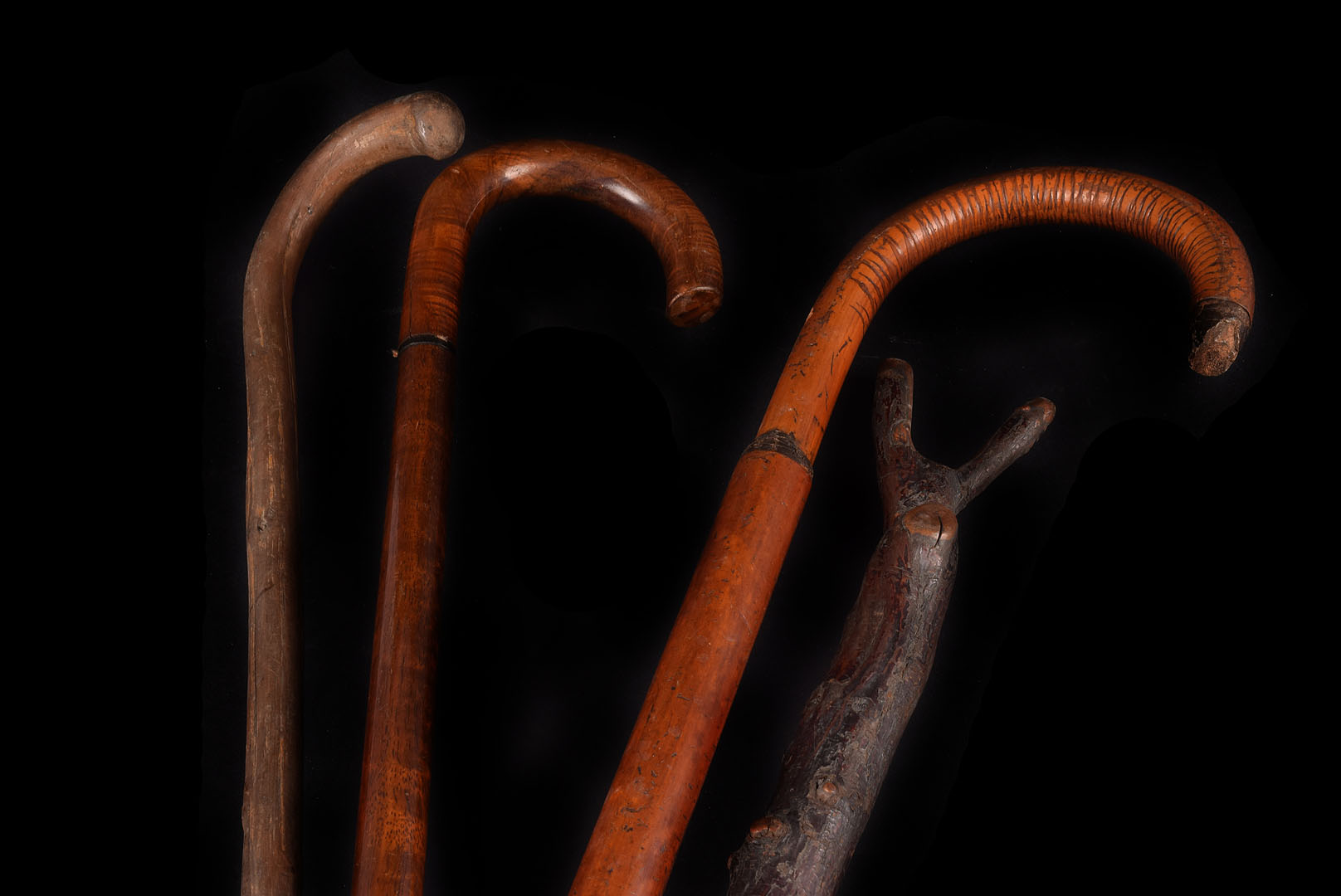 Two vintage shooting sticks, together with 3 walking sticks 2 riding whips and a mahogany book