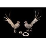 A pair of silver plated pheasants, realistically modelled with red paste set eyes, 22cm long,