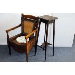 An Edwardian period commode chair, with lifting rattan seat enclosing a stoneware covered chamber