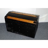 A vintage travel trunk, black painted with wooden struts to top, opening to reveal lift out tray