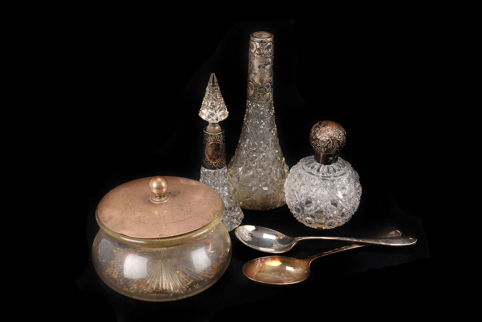 Three early 20th century silver mounted cut glass scent bottles, together with a silver covered