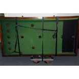 A vintage oak bar billiards table, coin operated, together with four cues, balls, dolly pegs, a