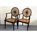 A set of four 19th century admiralty back dining chairs, two with arms, each with roundal back splat