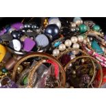 A quantity of costume jewellery, including various beads, bangles, brooches and other items