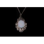 An opal pendant, the oval stone with black enamel verso, in a white metal open work mount, 45mm
