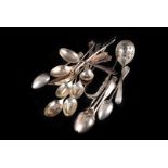 A small collection of modern silver spoons, including a set of four rococo themed teaspoons and