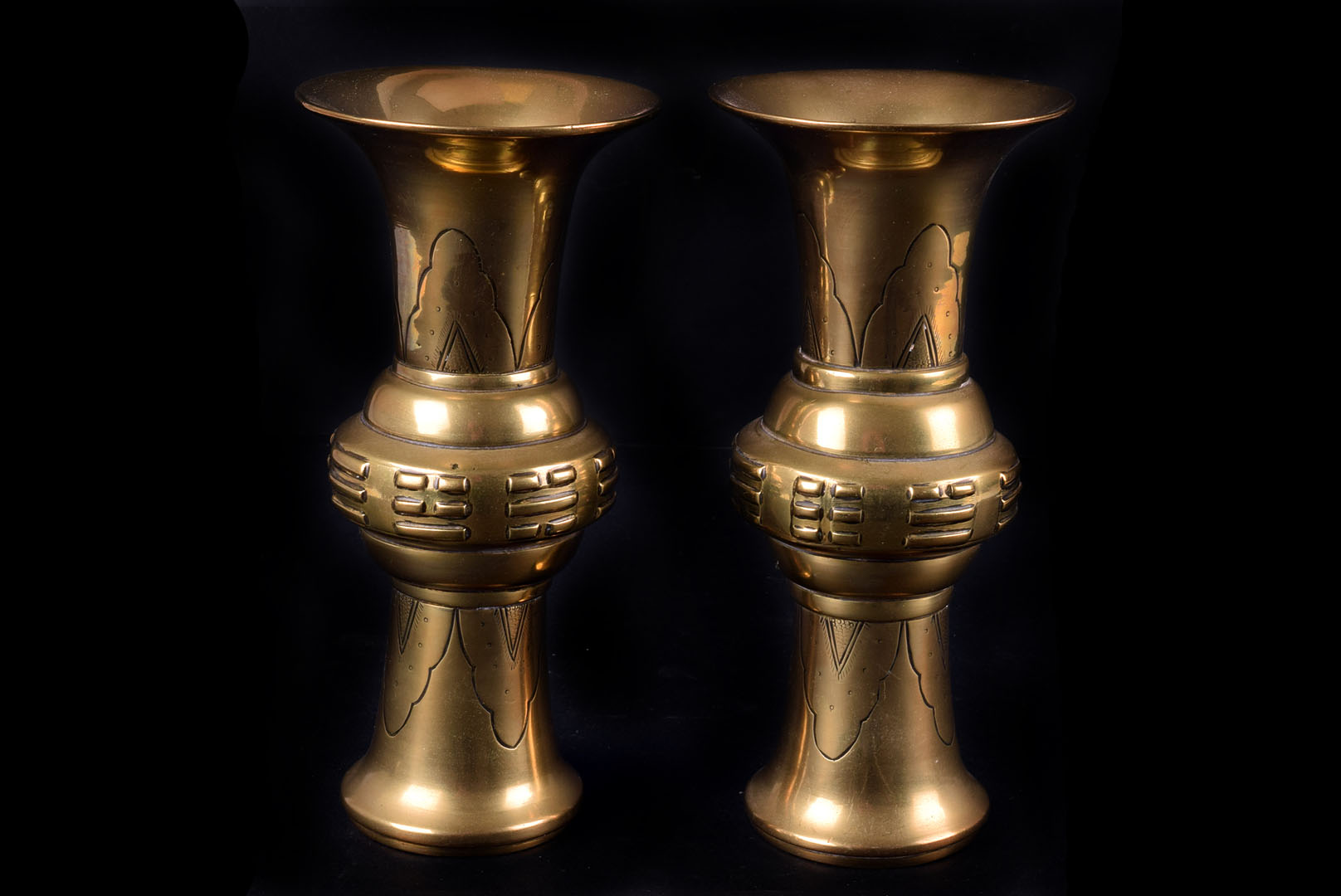 A pair of modern Chinese brass vases, the yan yan style vessels with engraved and raised designs,