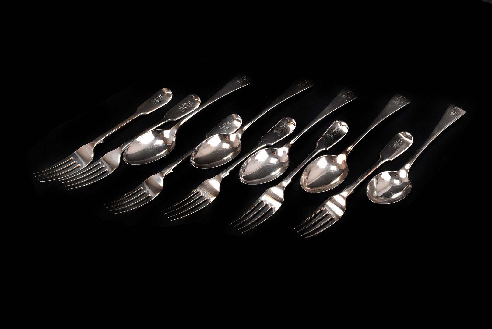 An associated set of five Victorian and later V silver forks and six dessert spoons by George