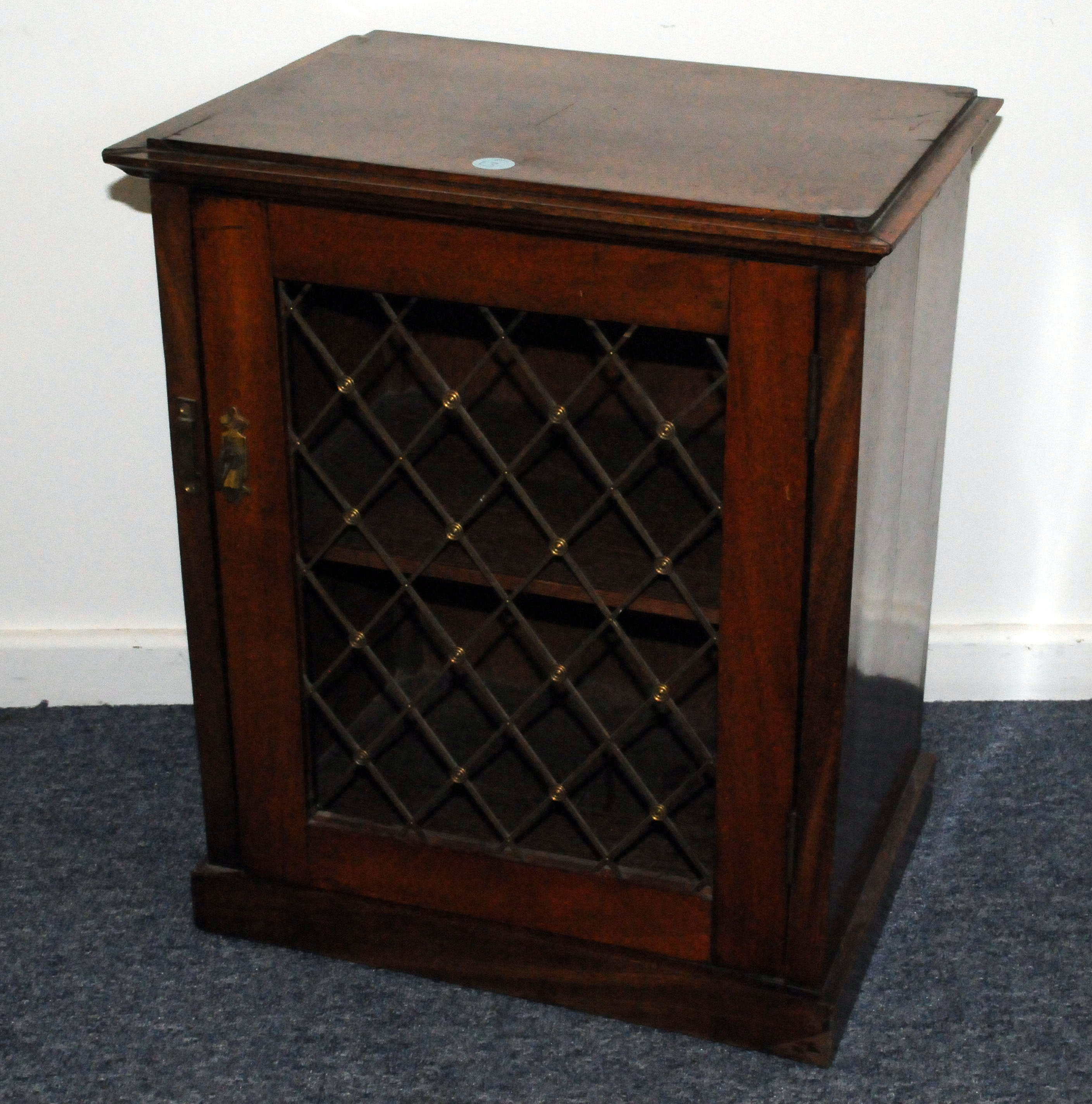 A small 19th century mahogany book cabinet, rectangular form with pierced brass grill to front of