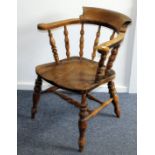 A Victorian captains style chair, in yew with carved arm supports