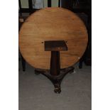 A Victorian mahogany snap top breakfast table, the faded circular top on octagonal column and