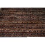 A late 19th or early 20th century Middle Eastern carpet, the finely woven runner style rug having