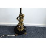 An Edwardian period brass standard lamp base, the column stem on base with cherub and four enamelled