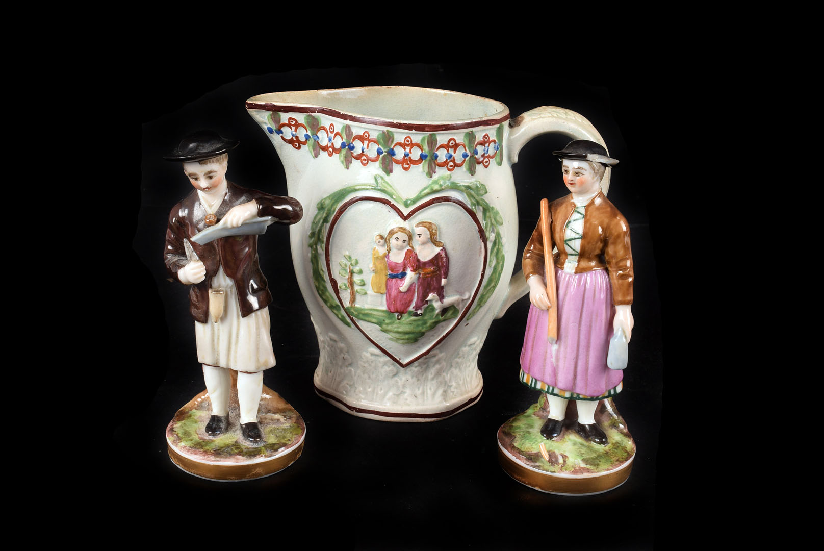 A pair of Russian porcelain figures, of a man whittling a piece of wood and a woman standing with