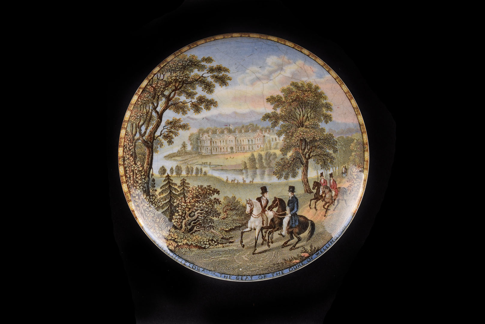 A Staffordshire pot lid, with Strathfields The Seat of the Duke of Wellington, some crazing