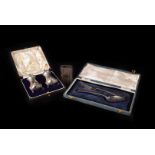 A cased pair of George V silver peppers from Elkington & Co, together with a silver matchbox