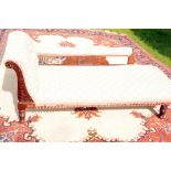 An Edwardian chaise longue, having modern upholstery to the stained beech frame