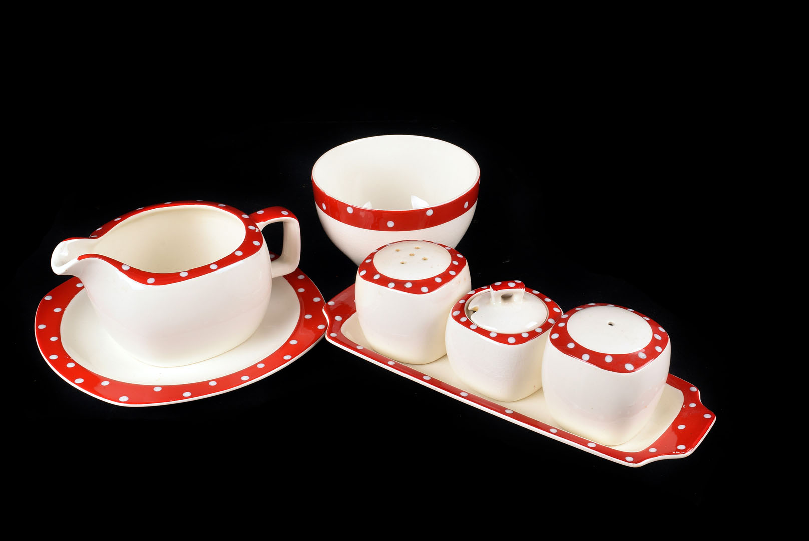 A Part Midwinter Polka Dot Dinner Service, with red borders and white polka dots, consisting of 1