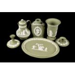 A large collection of green Wedgwood Jasperware, comprising a large bowl, table lighter, jugs,