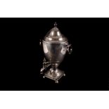 A large 19th century silver plated urn, of oval shape with circular handles, on a square base with