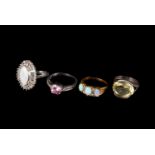 A group of four gem set dress rings, including a silver gilt three stone opal ring, a large opal and