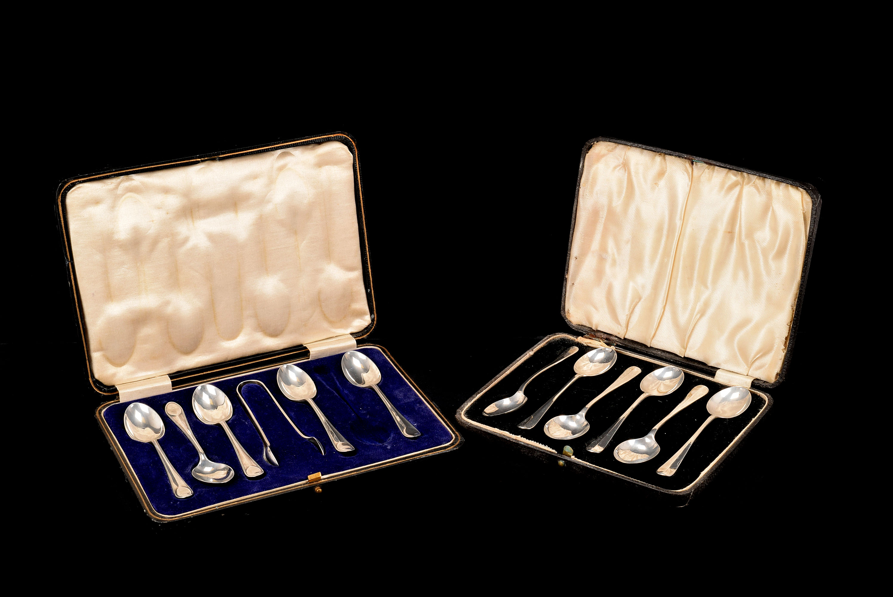 A collection of silver flatware, including a cased set of six teaspoons, two cased sets of six